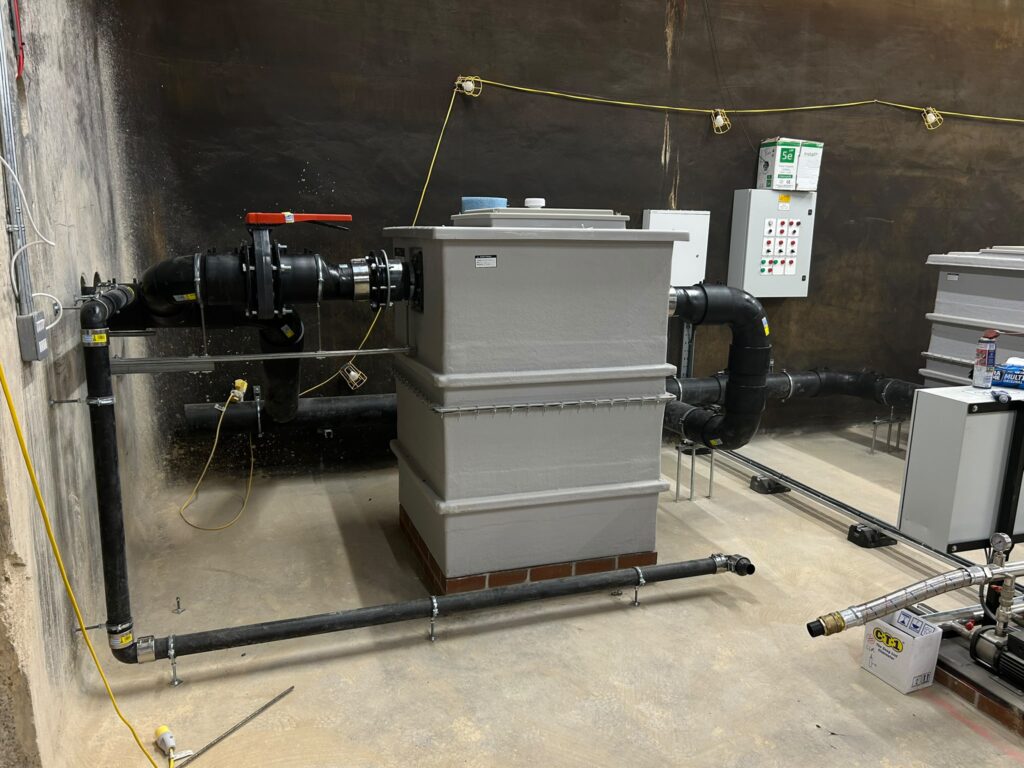 Three rainwater storage tanks connected in series with pump discharge system